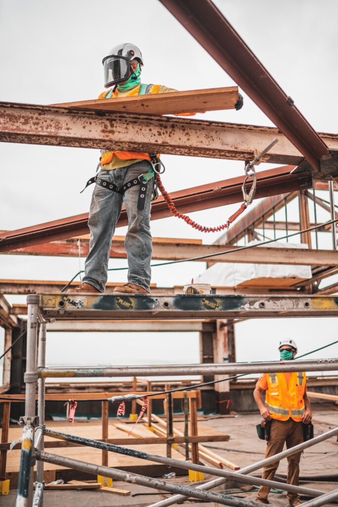 man working on construction site on beams